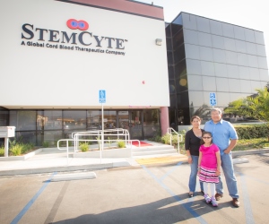Itzel Cervantes and parents next to the StemCyte laboratory
