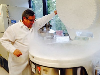 Roger Mrowiec opening a cryogenic dewar at Community Blood Services