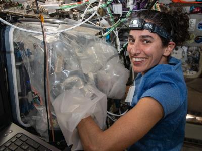 Astronaut with Redwire 3D BioFabrication Facility (image credit NASA)