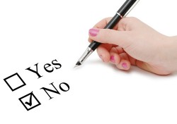 image of a woman's hand checking yes/no boxes on a form